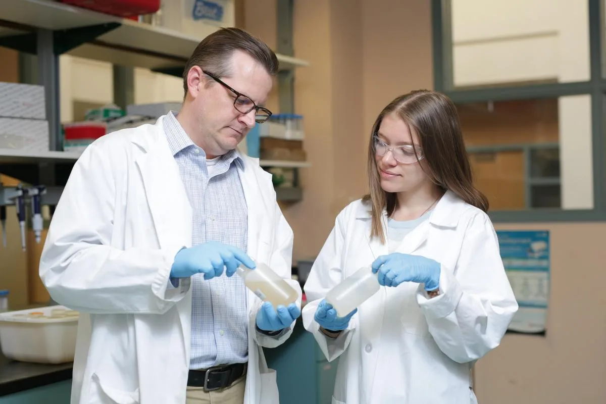 Professor and student working on research at Mines