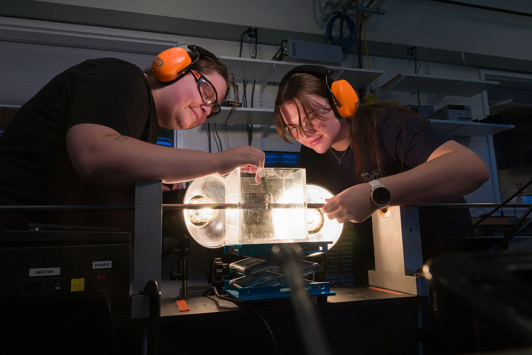Student researchers in the graduate mechanical engineering lab performing a Kolsky bar dynamic compression experiment