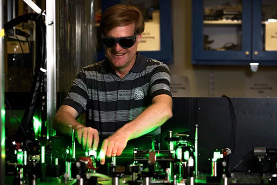 Quantum Physics researcher wearing protective sunglasses