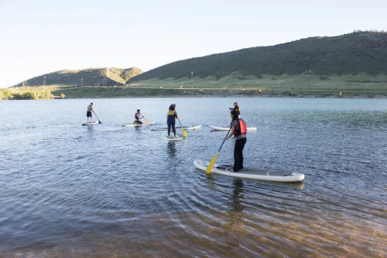 Students paddle boarding