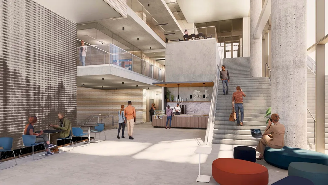 Modern lobby with people sitting, walking, and ordering at a cafe near stairs and glass railings in a bright, open-concept space.