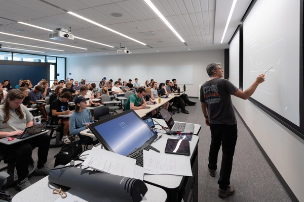 Professor Eric Mayotte lectures to a full classroom