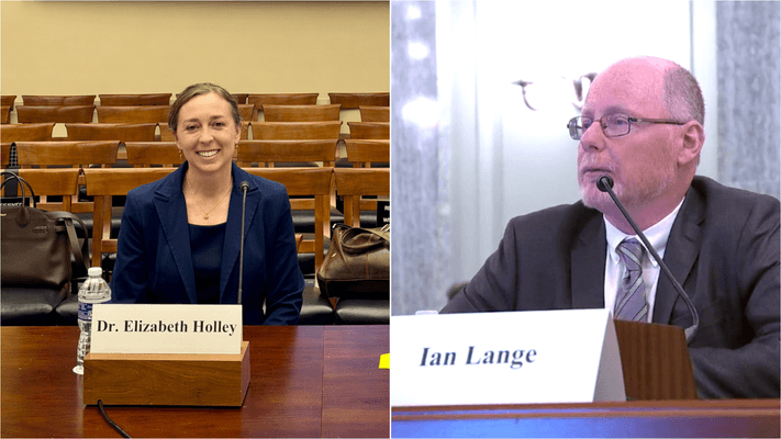 Elizabeth Holley and Ian Lange sit at table behind signs with their names on them