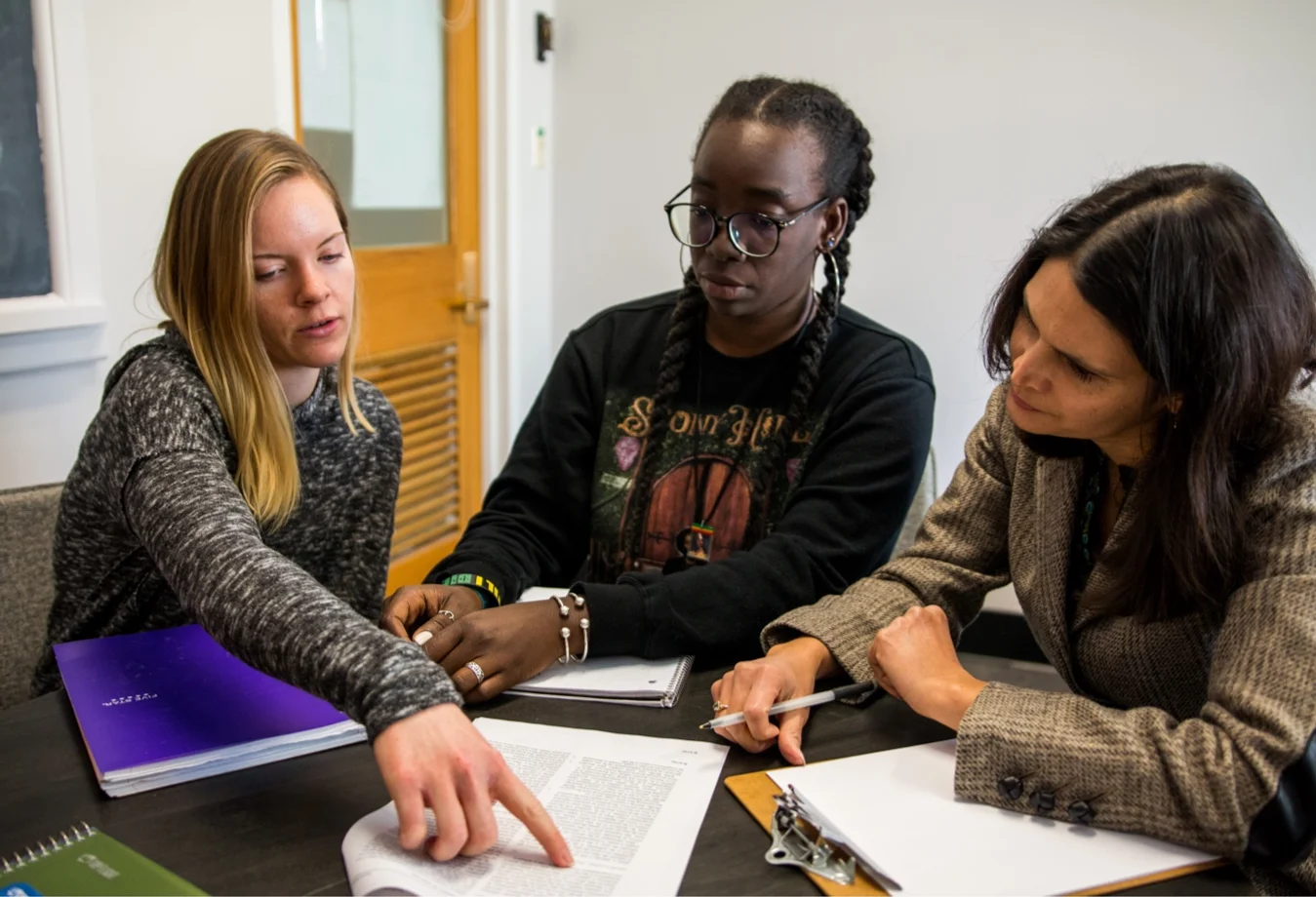 Two female Mines students reviewing work with a female professor.