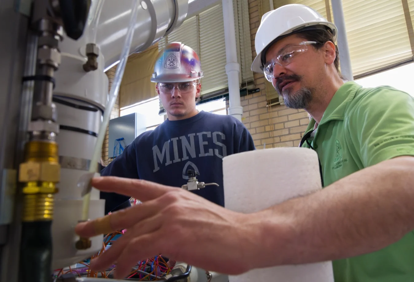 A mines professor showing a student the gauges and measurements on water filters.