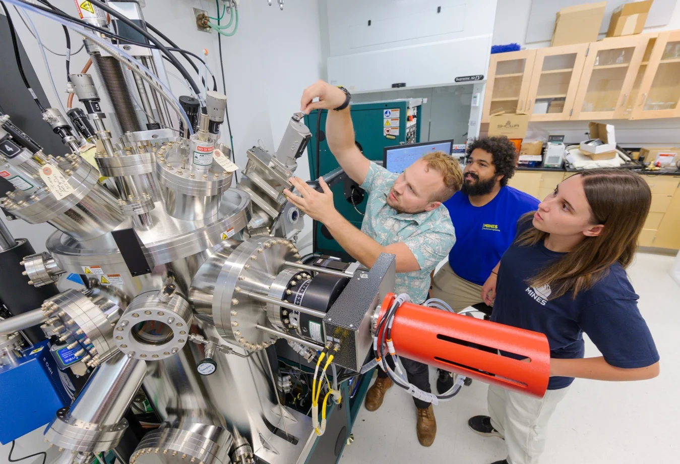 Researchers working with a sophisticated nanofabrication and thin film deposition instrument at the Colorado School of Mines