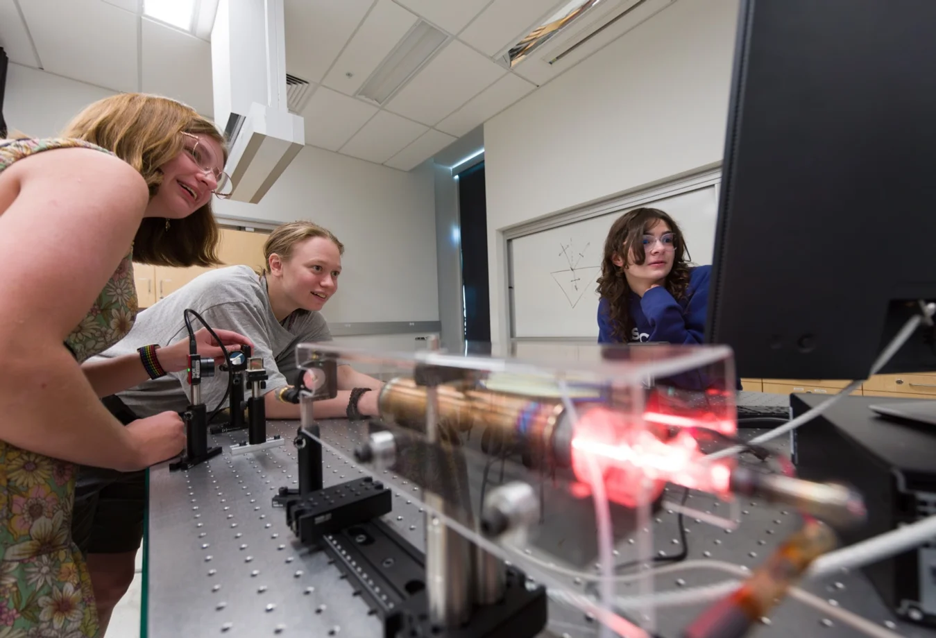 Three Mines students performing high-harmonic generation experiments