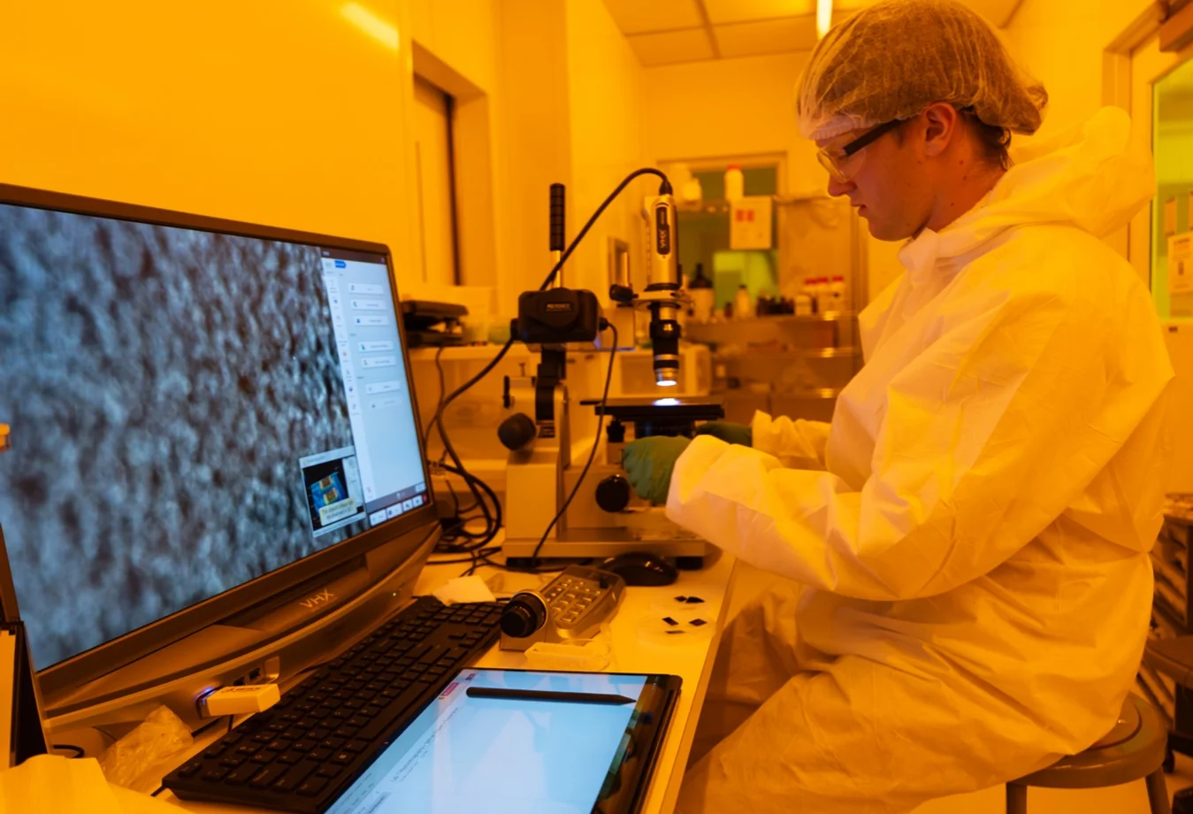 A Mines researcher working in a specialized nanofabrication cleanroom environmen
