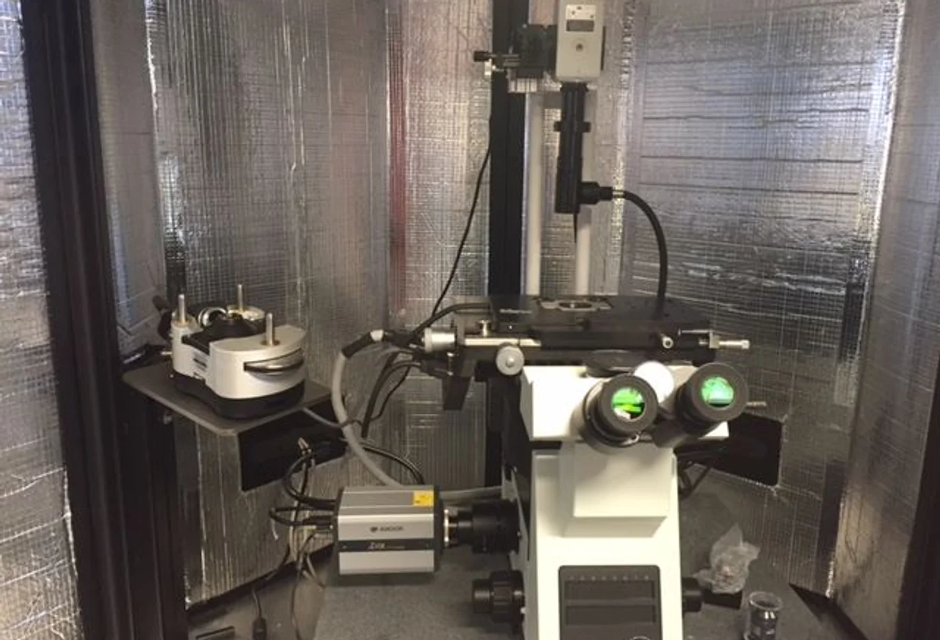 A microscope sitting on top of a table in a room.