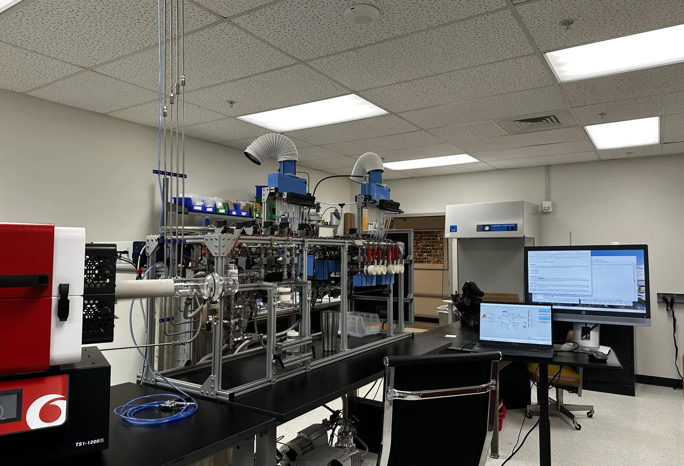 A laboratory with a computer and a monitor on a desk.