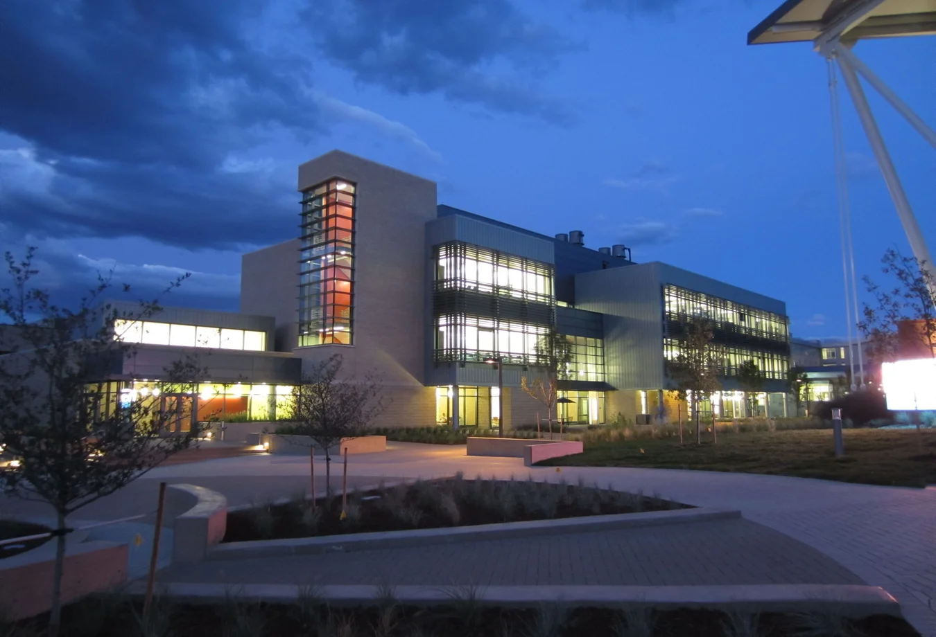 A large building with a lot of windows at night.