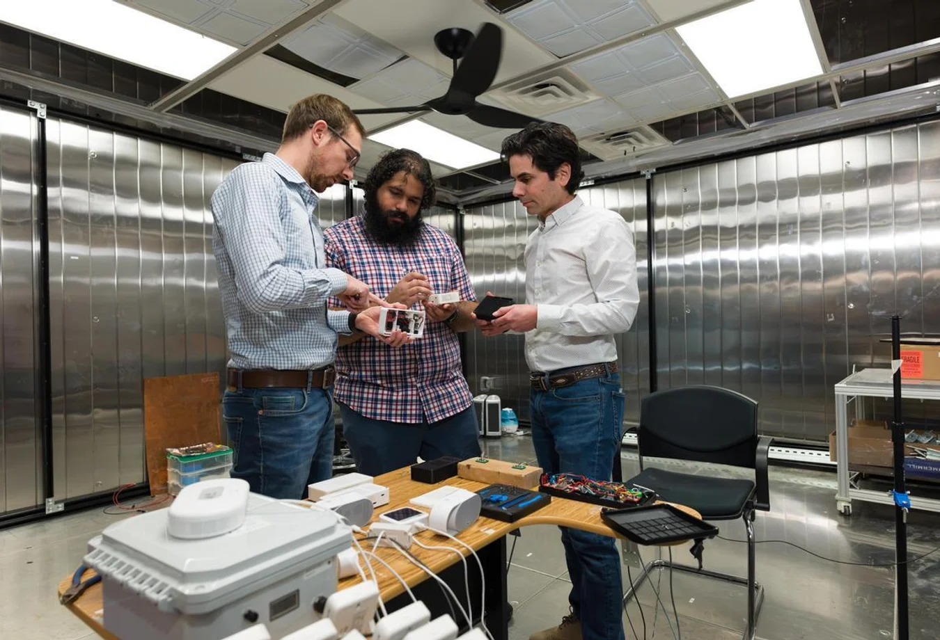 Paulo Cesar Tabares Velasco, Andy Gloor and Quin Guy with indoor air quality data acquisition system. This system is designed to measure temperature, relative humidity, particulate matter, CO2, and other gases.