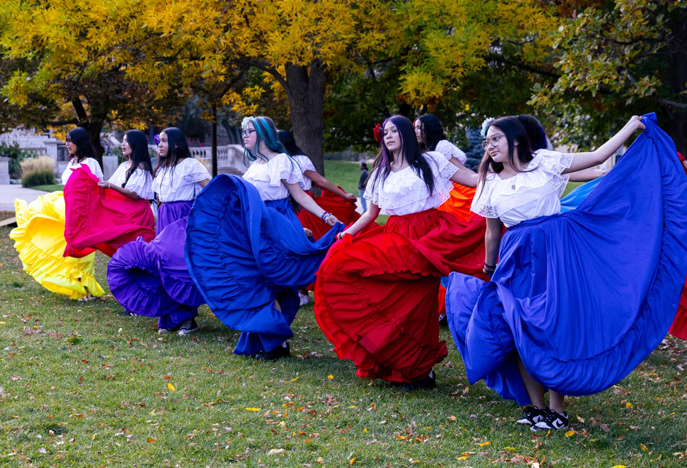 Colorado School of Mines student dancers wearing colorful dresses at the SHPE Carnival