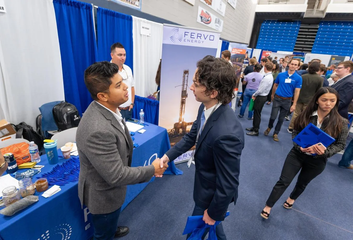 A Mines student shakes hands with a professional in the energy industry as part of the annual Career Days event.