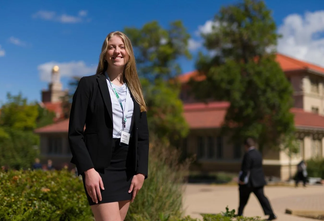 Mines student standing in a business suit preparing for a leadership workshop.