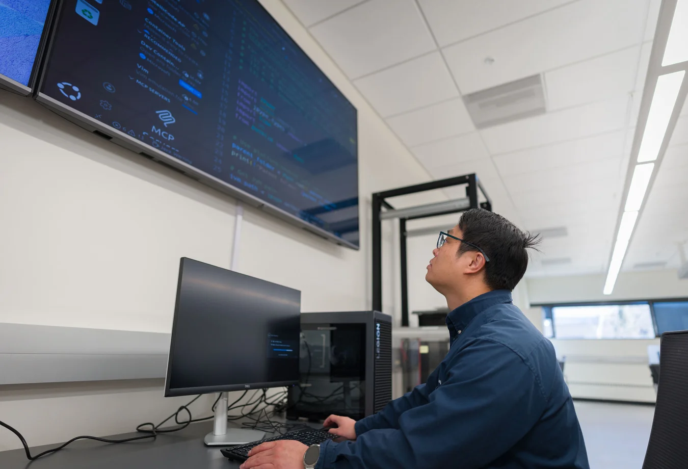 A man sitting at a desk in front of a computer.