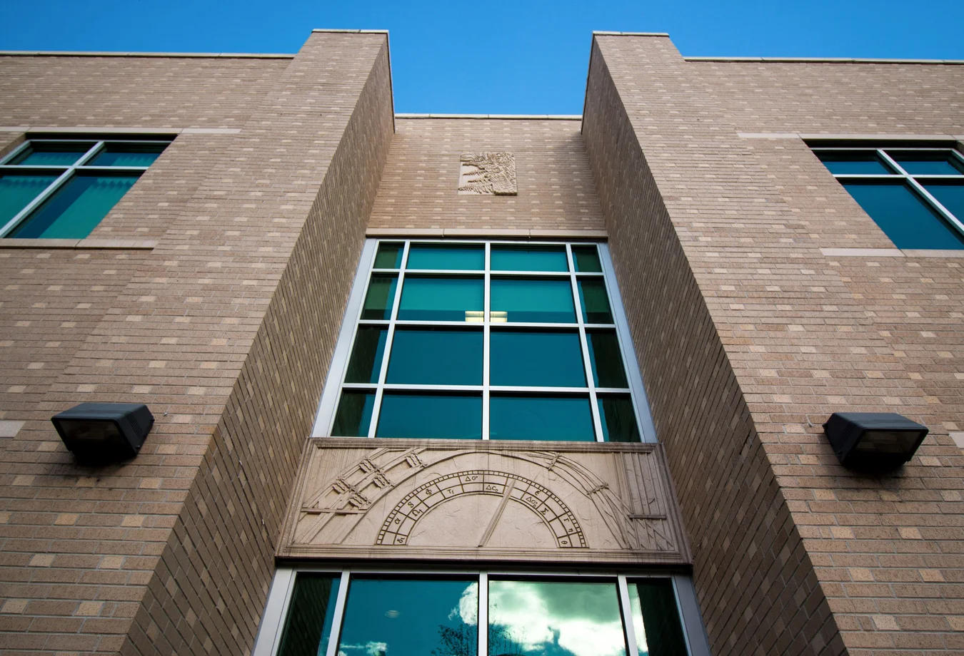 A brick building with a clock on the side of it.