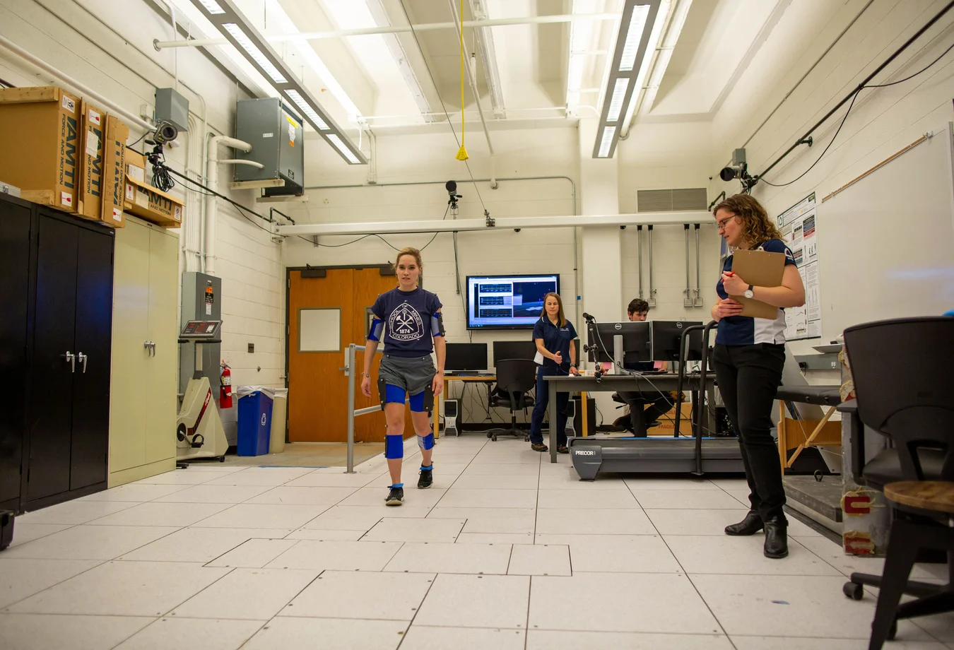 A group of people walking through a large room.