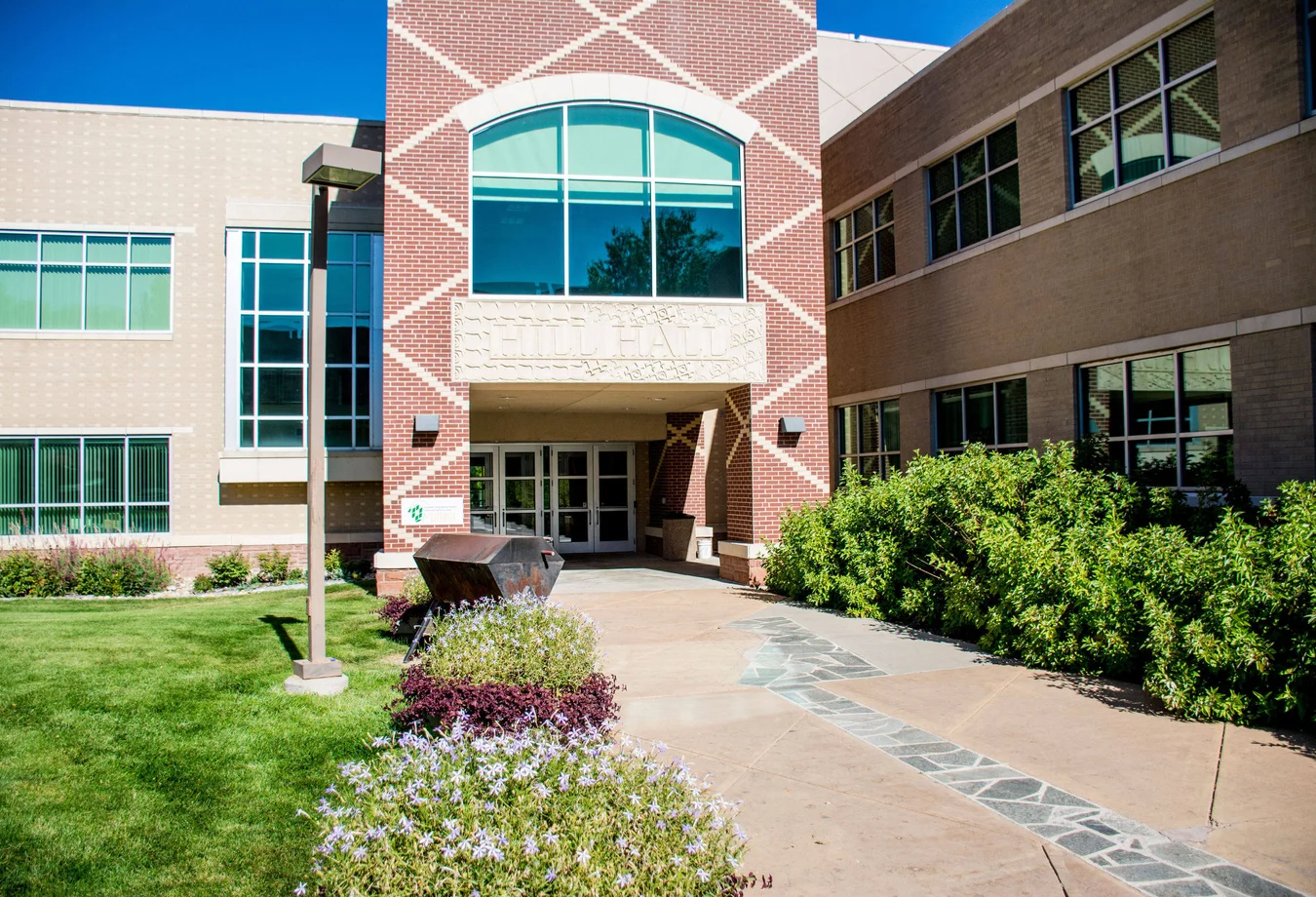 A brick building with a walkway in front of it.