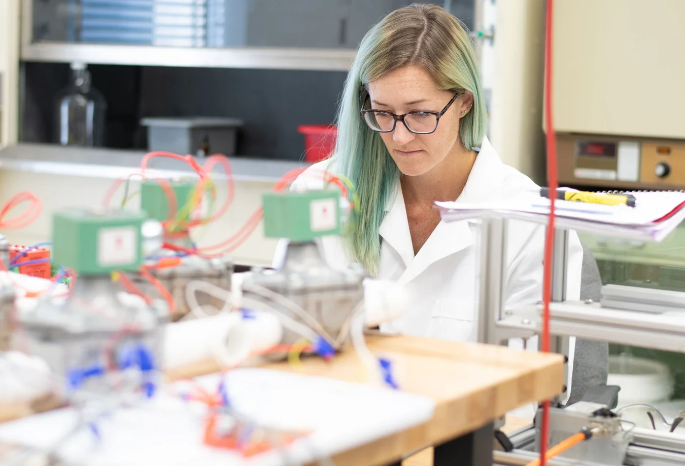A woman in a lab coat working on a project.