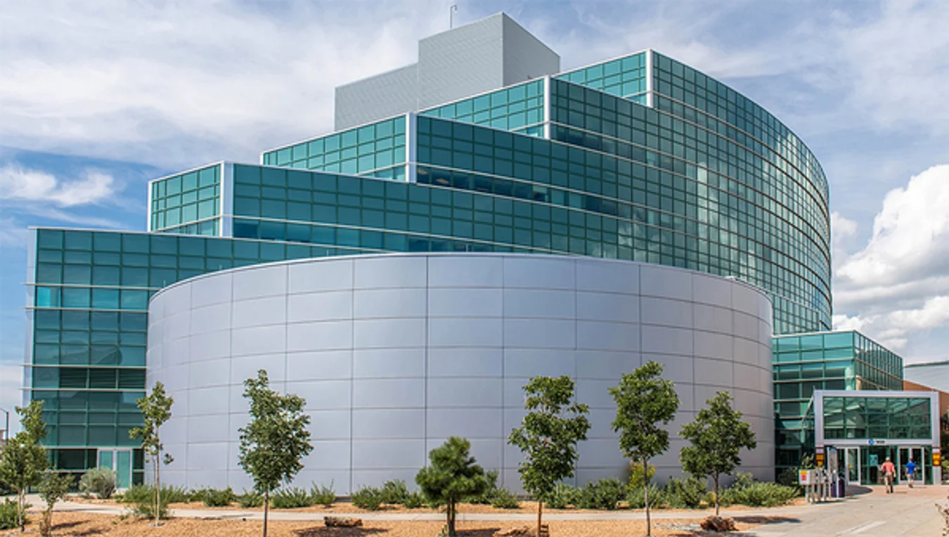 Exterior photo of Los Alamos National Laboratory's turquoise glass building in New Mexico.