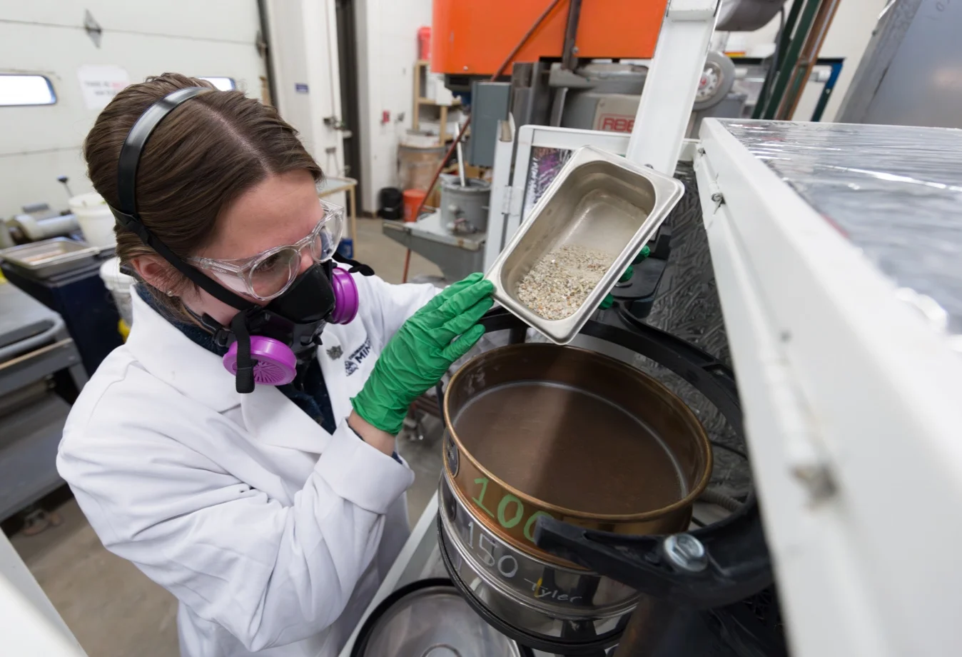 A Mines student researcher working with mineral samples, which is part of a broader initiative to secure critical mineral supplies.