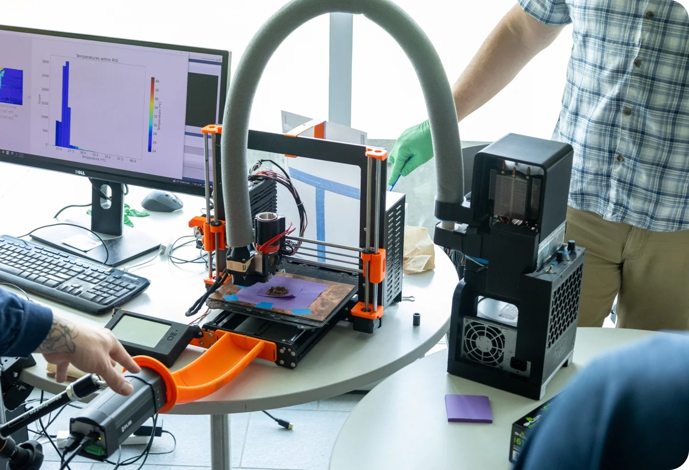 Mines students working with a Original Prusa i3 MK3S+ 3D printer