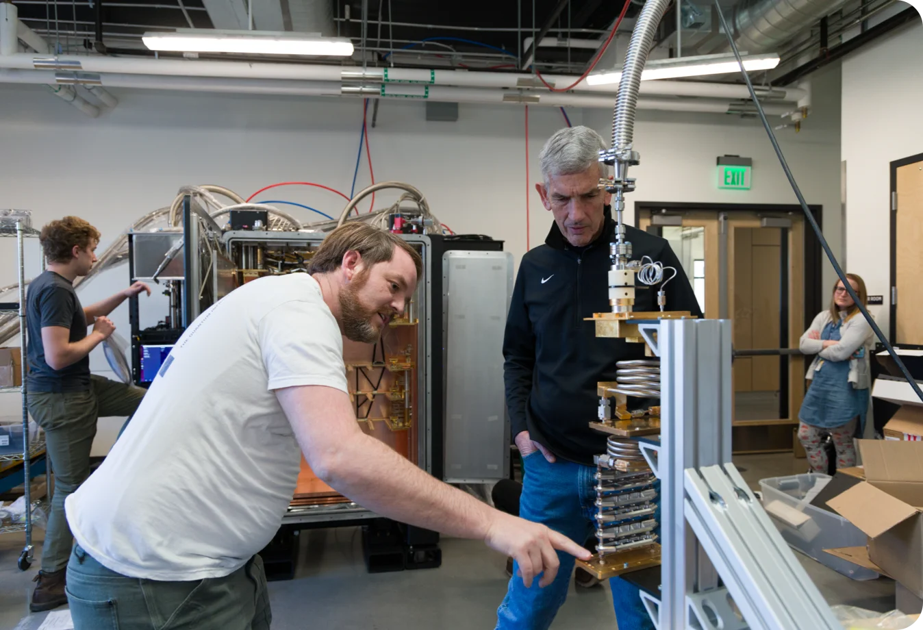 Mines President Paul C. Johnson and Maybell Quantum CEO Corban Tillemann-Dick discuss the Maybell Big Fridge currently in the final stages of qualification in a space inside the Labriola Innovation Hub on the Mines campus.