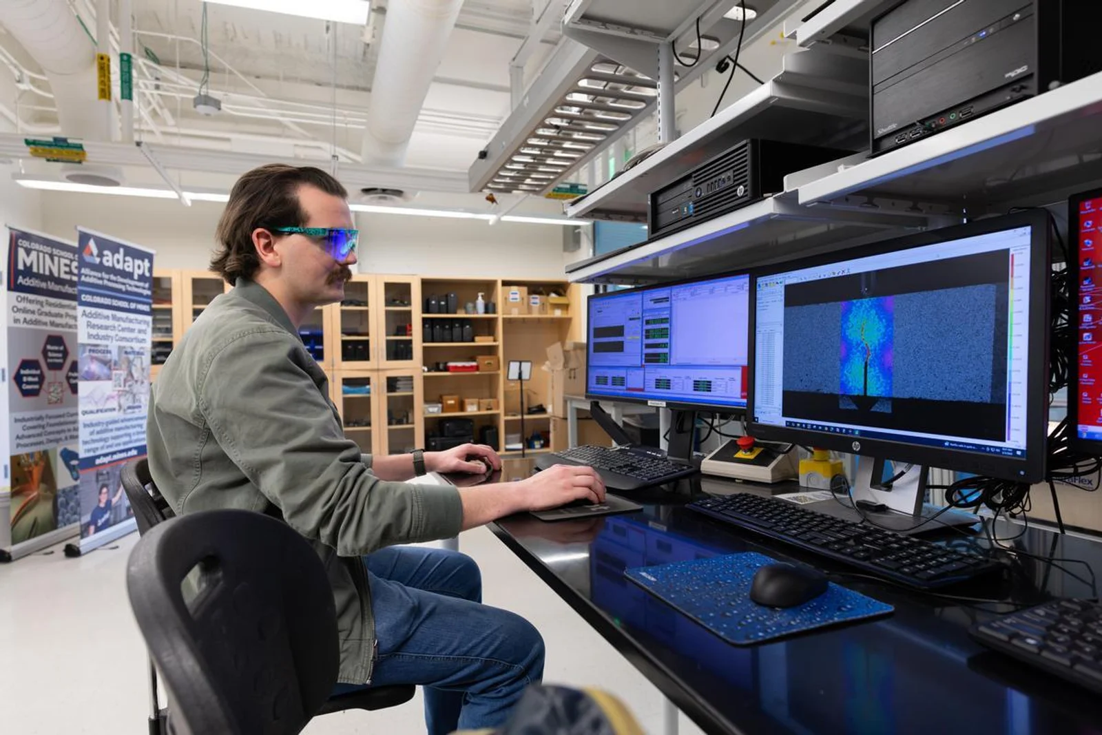 Postdoc Edwin Glaubitz sets up a load frame for mechanical testing in the CoorsTek Center’s Materials & Manufacturing Research Lab.