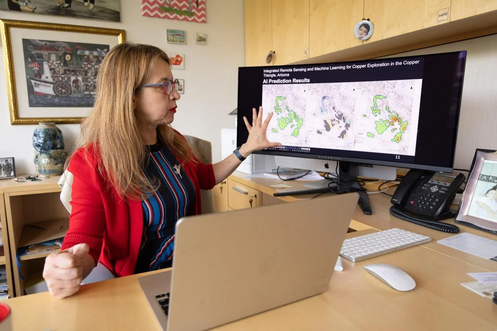 Sebnem Duzgun, Fred Banfield Distinguished Endowed Chair and professor of mining engineering, reviews AI prediction results from her machine learning research on copper exploration in her office at Colorado School of Mines.