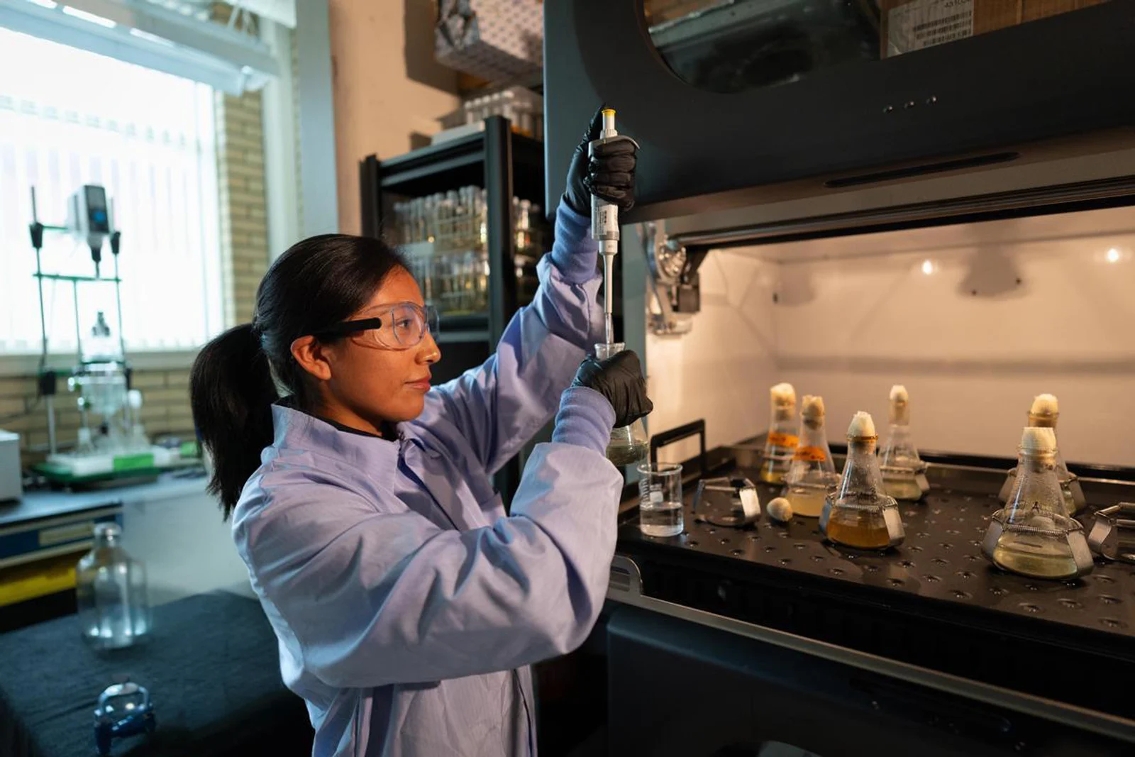 A Mines researcher performs extractive metallurgy experiments on critical minerals in a lab in the Kroll Institute.
