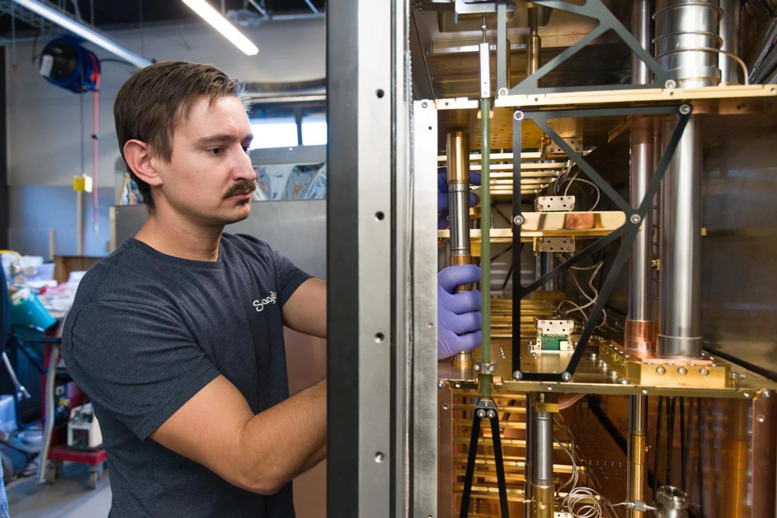 Researcher working with a quantum cooling fridge