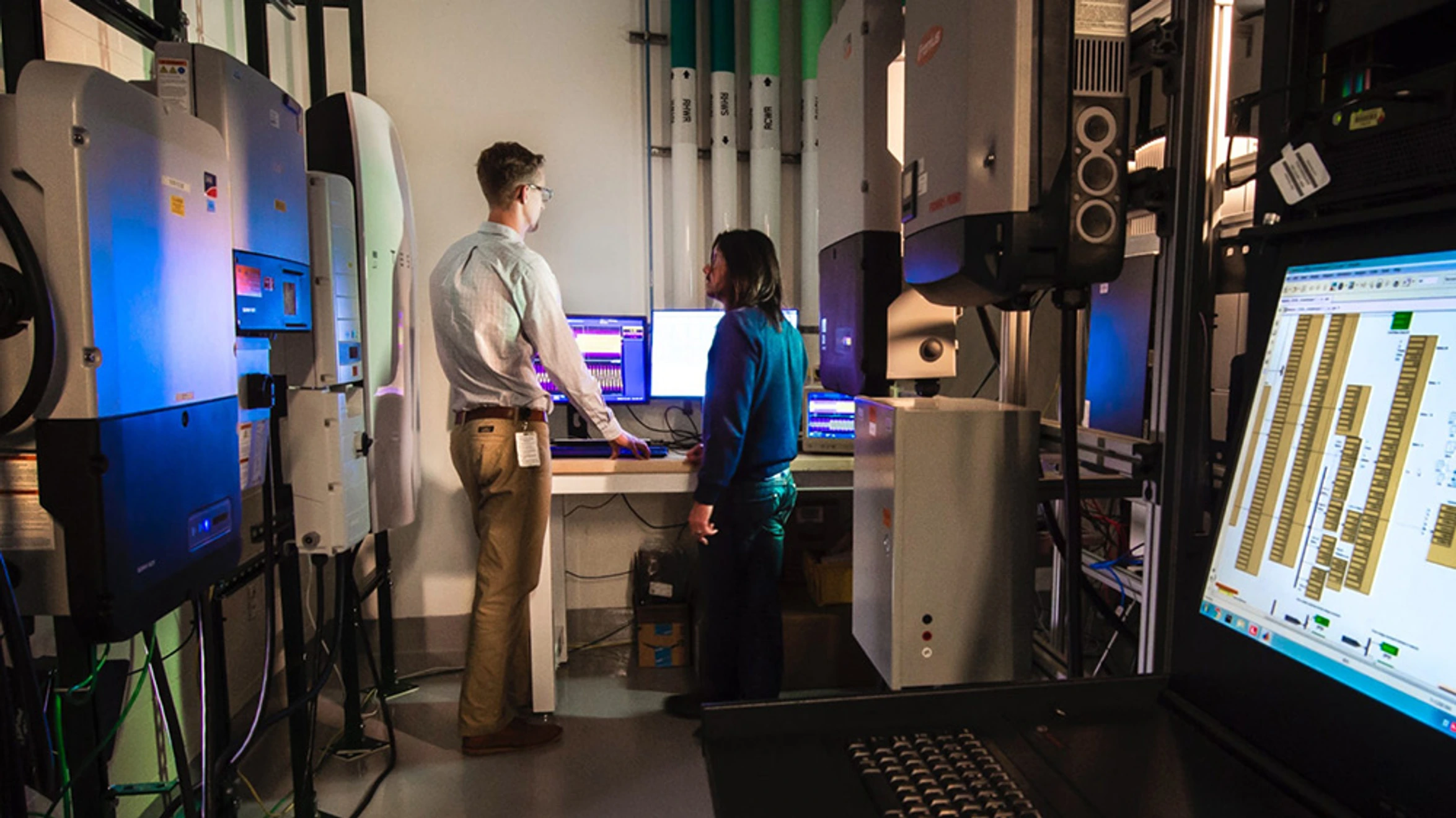 A man and a woman looking at a computer screen.