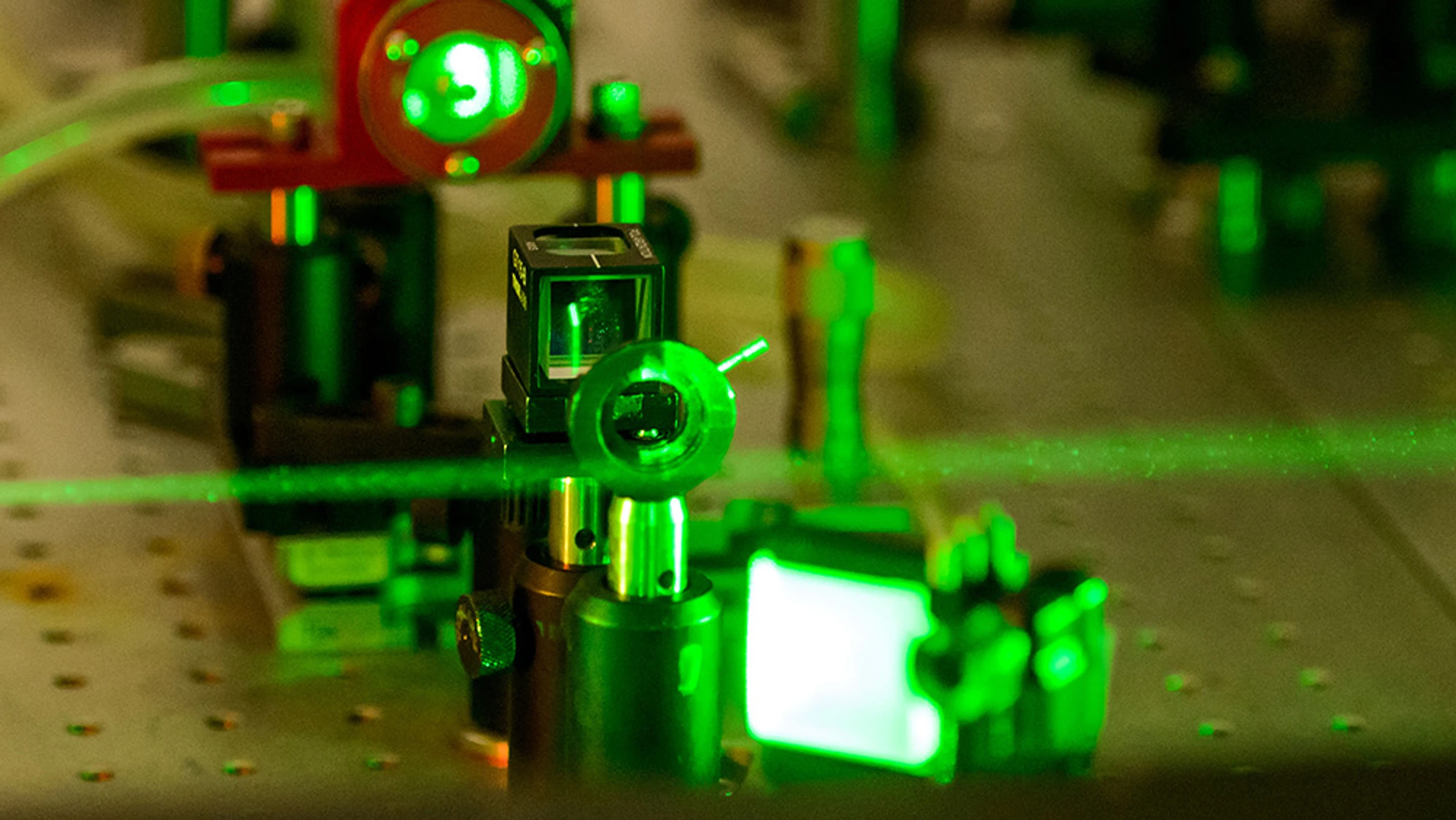 A green laser is being used on a machine.