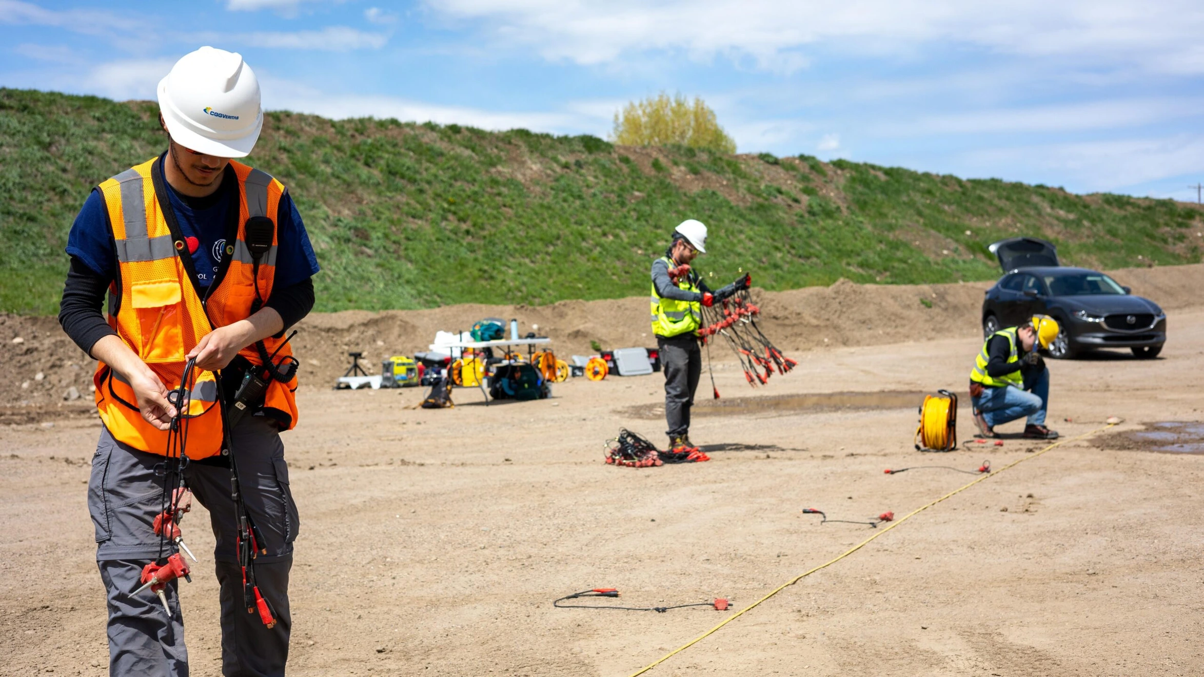 A group of men in hard hats and safety vests working on a construction site.