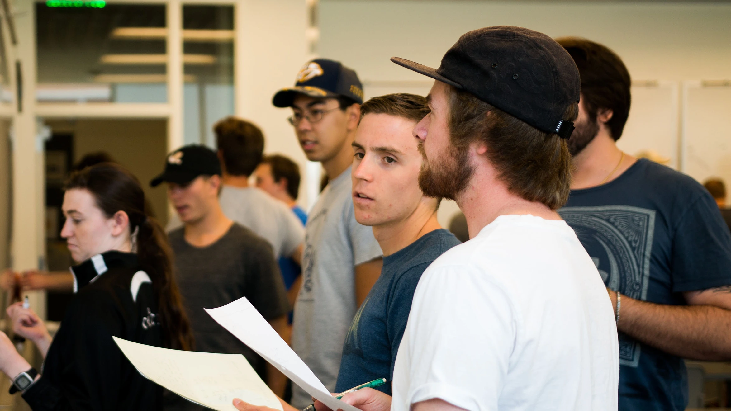 A group of young men standing in a room.