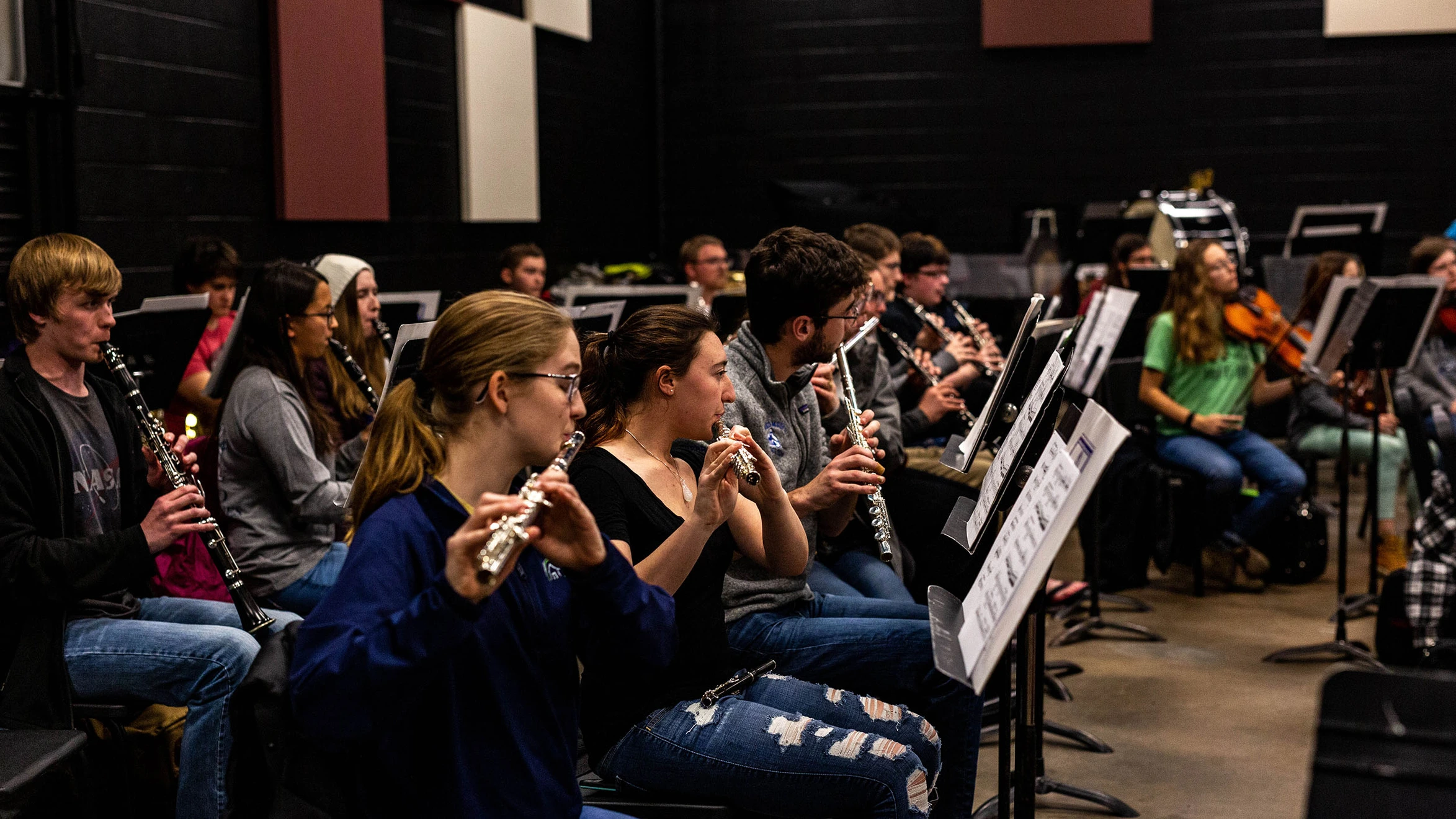 A group of people playing clarinets in a band.