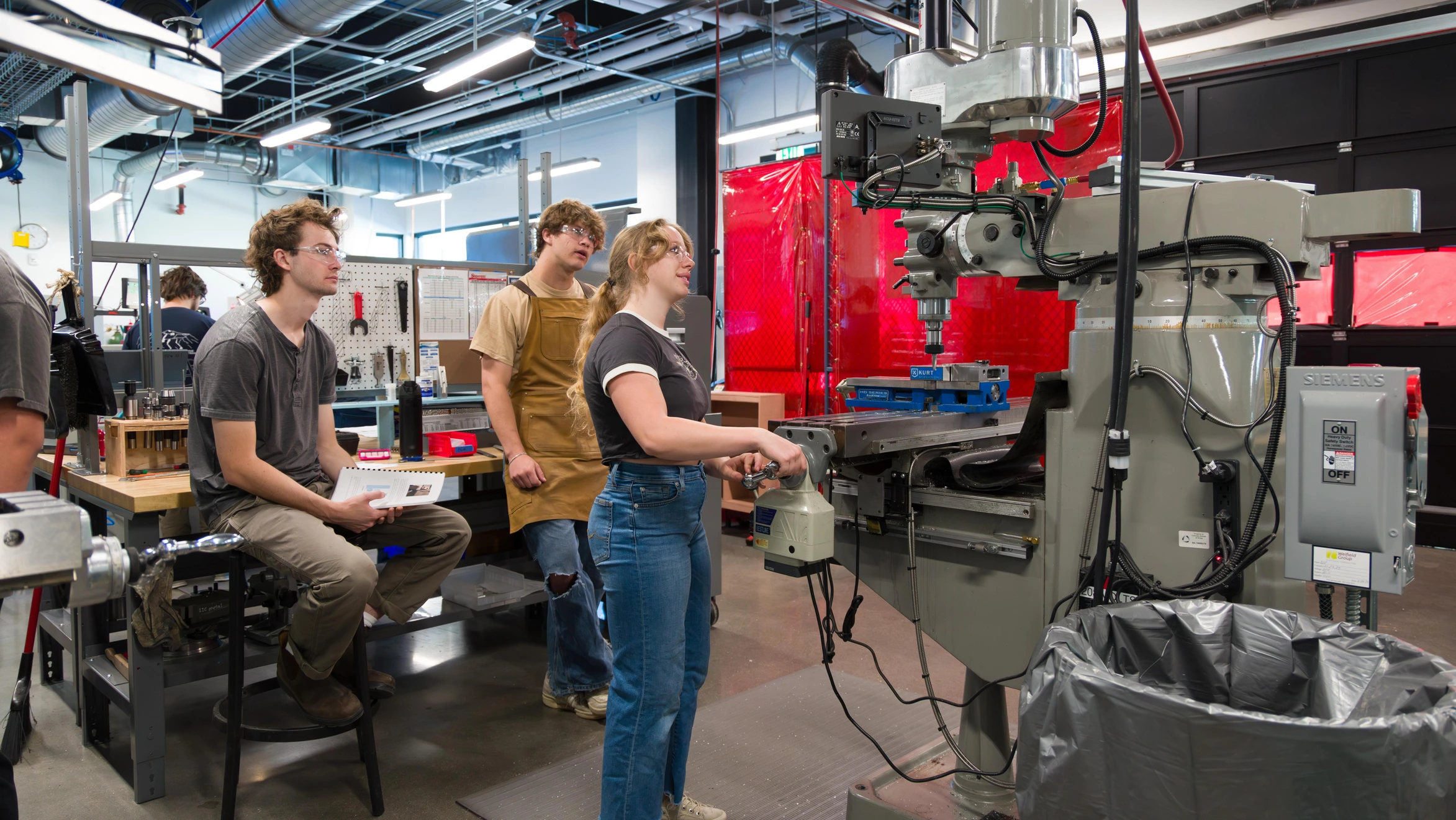 A group of people working on a machine in a factory.