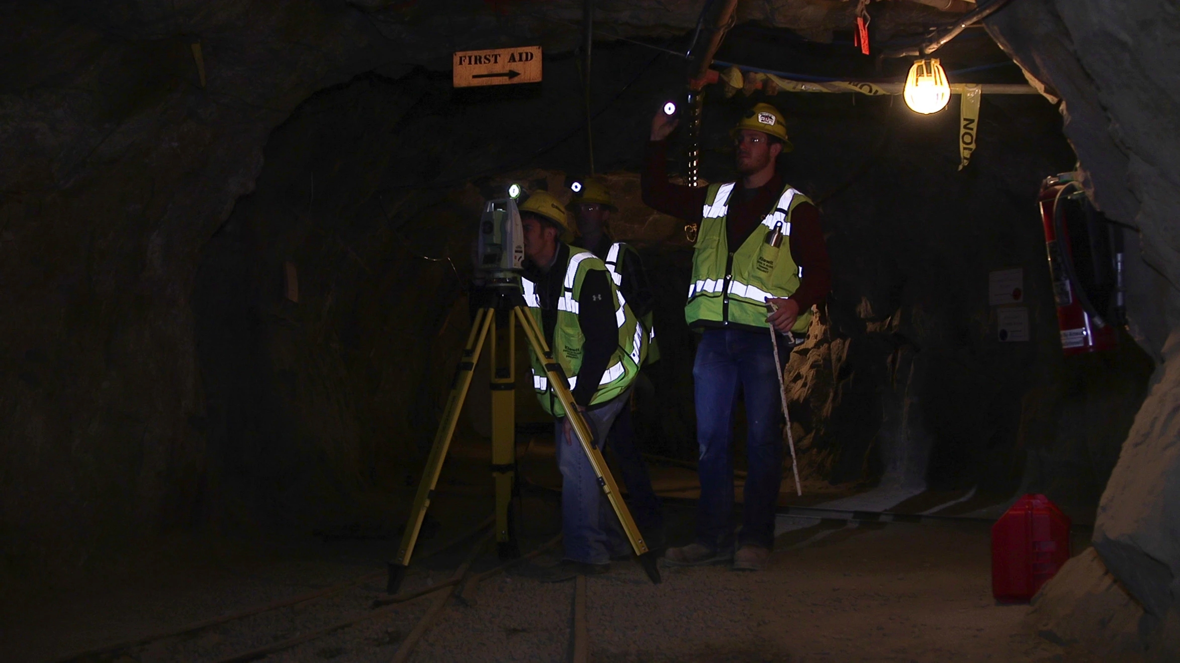 A group of men standing in a dark tunnel.