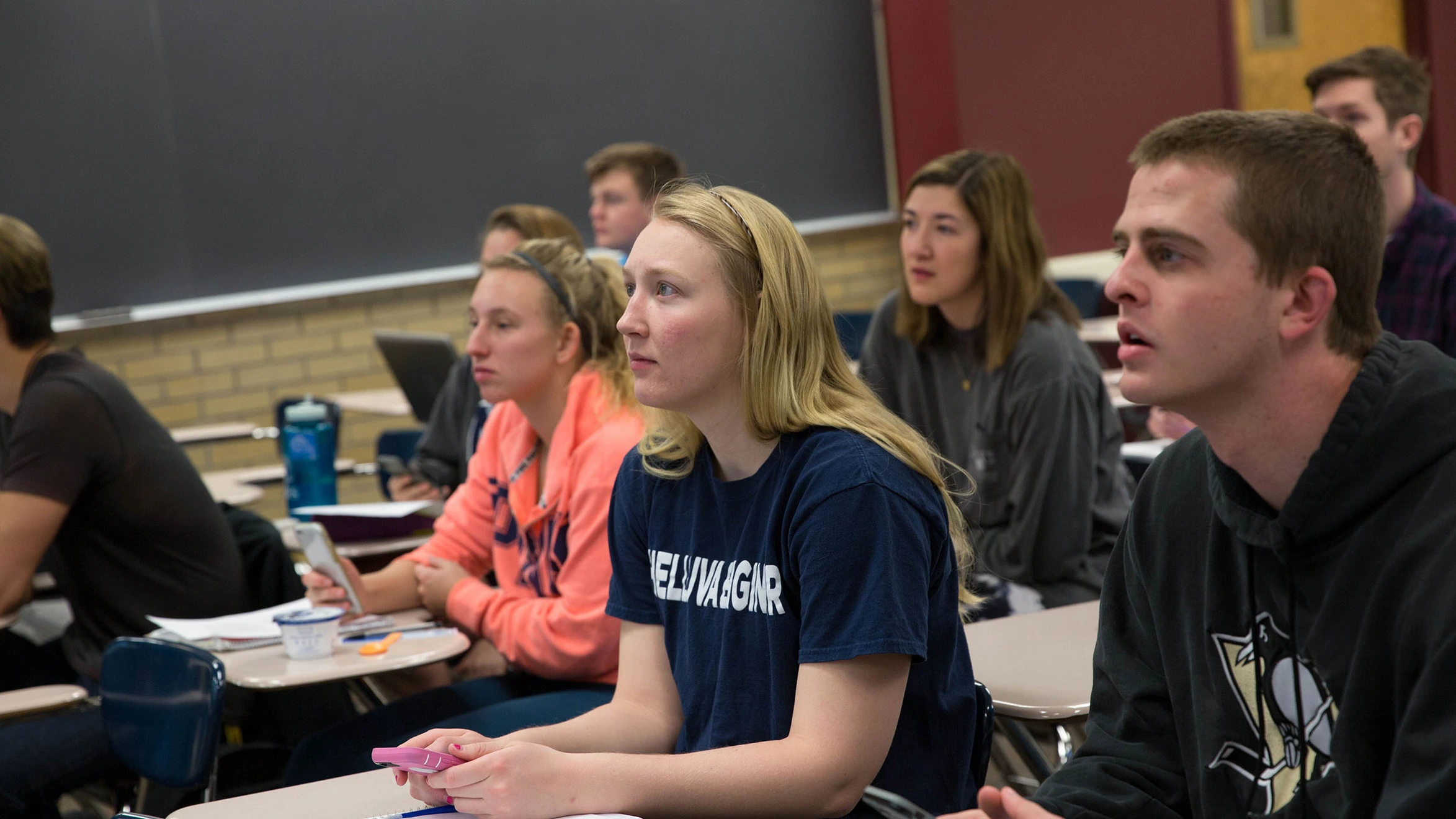A group of students sitting at desks in a classroom.