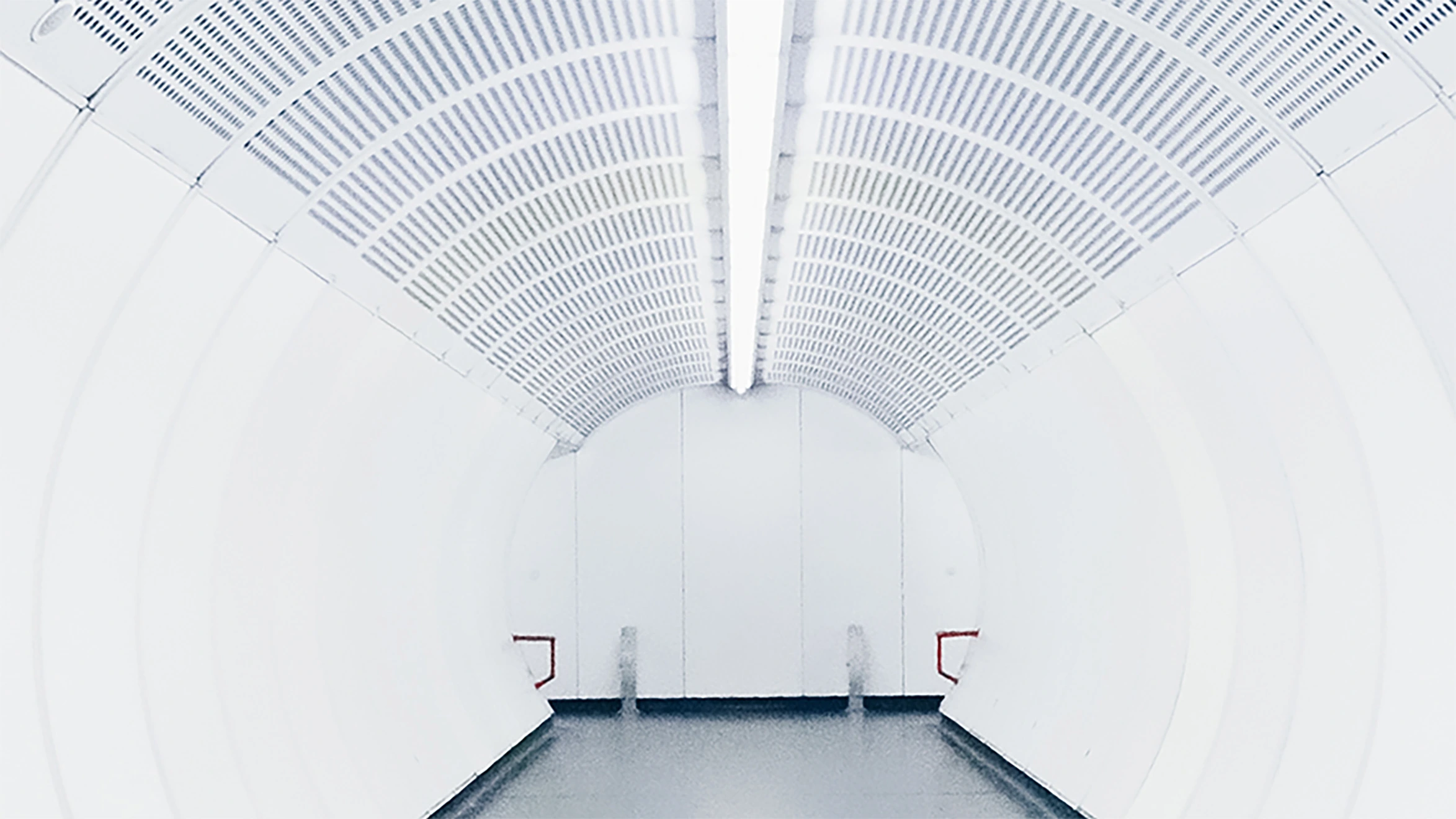 A long white tunnel with a light at the end.