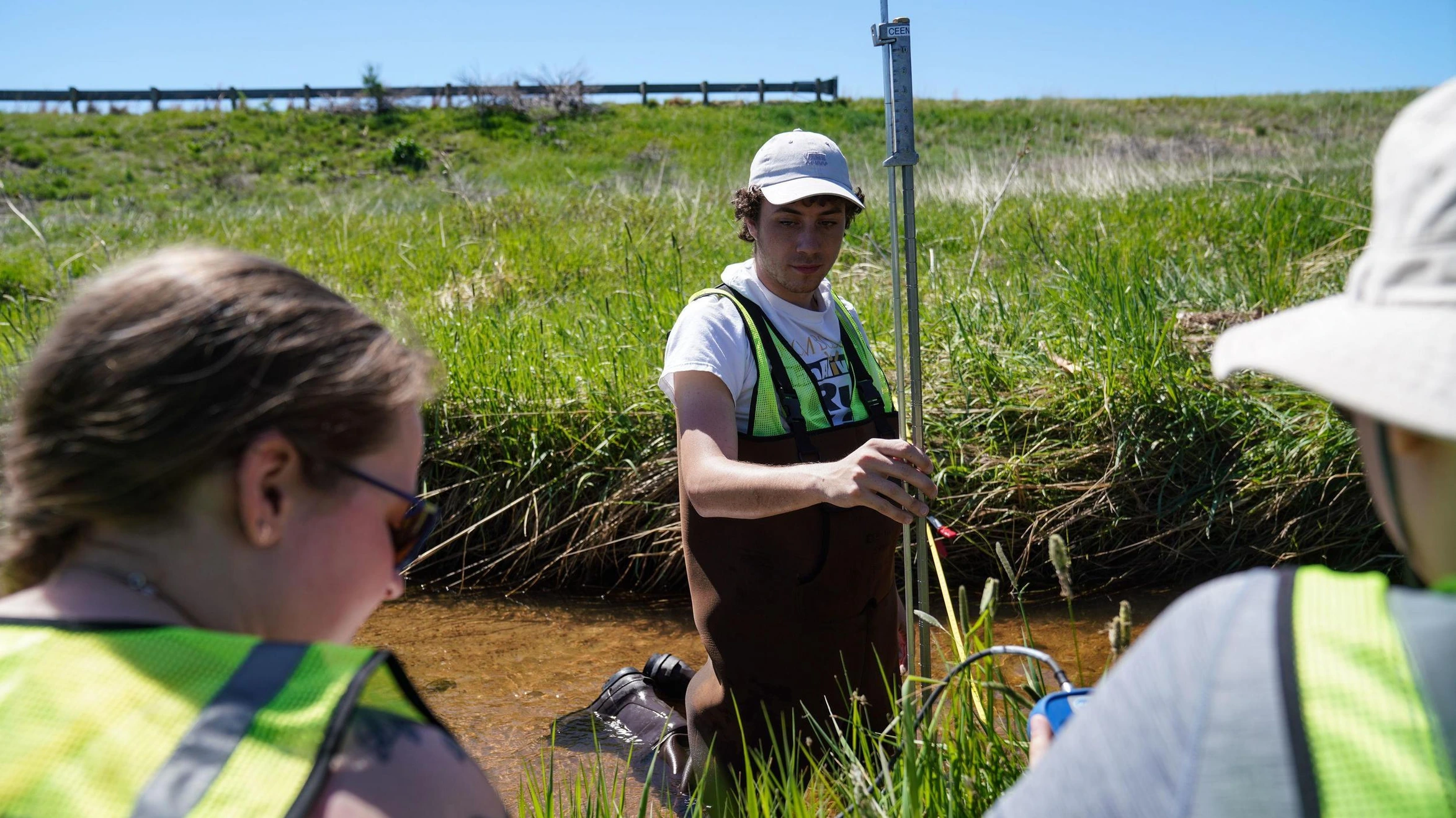 Mines Environmental Engineering students capture data in a stream at Chatfield Reservoir.