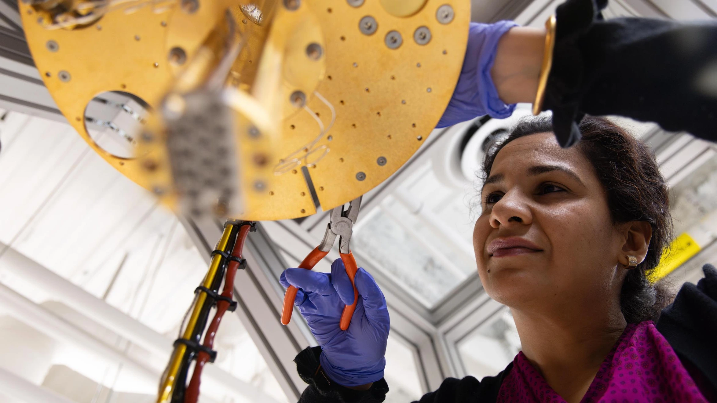 A member of the Mines Quantum Systems Engineering team works on a quantum dilution refrigerator.