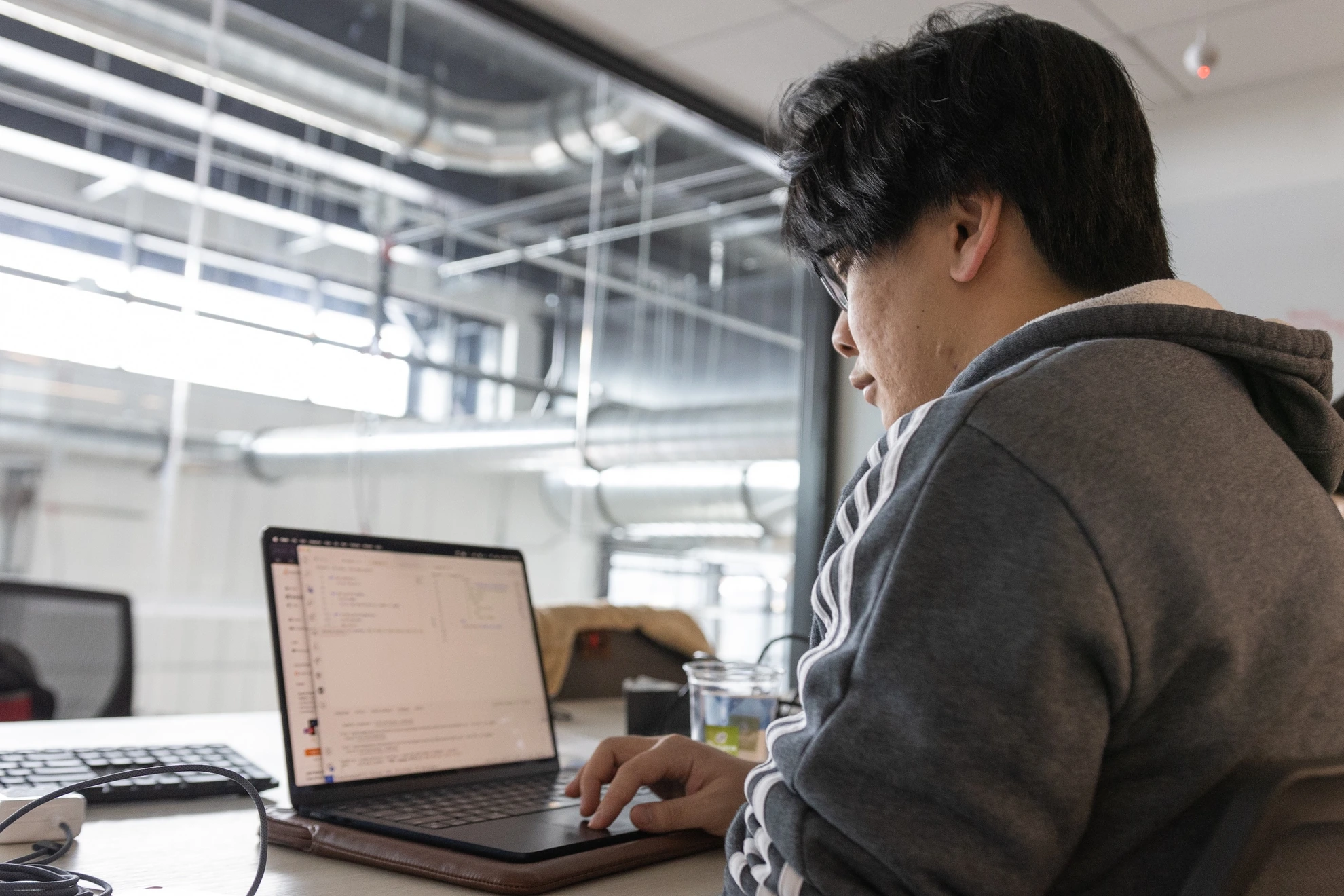 A Mines student works on a laptop during a campus hackathon.