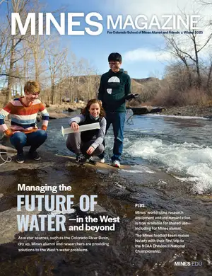Cover of Mines Magazine Winter 2023 issue with three researchers study water flow in a rocky river, using scientific equipment, with leafless trees and hills in the background.