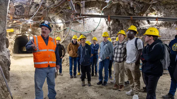 A mining engineering teacher speaks to a group of Mines students in a tunnel inside Edgar Experimental Mine.