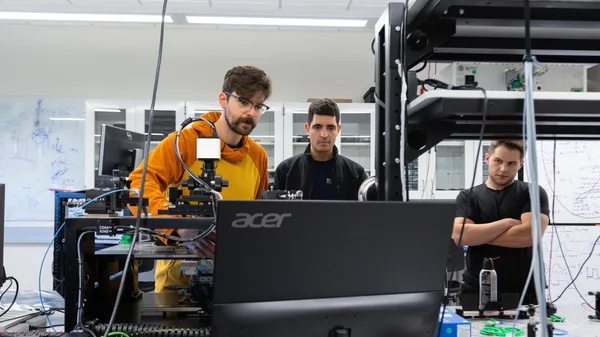Students in a lab performing Electrical Engineering microwave experiments.