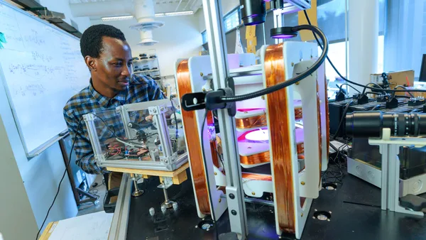 A man working on a machine in a lab.