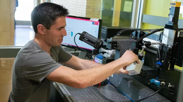 A man working on a machine in a lab.