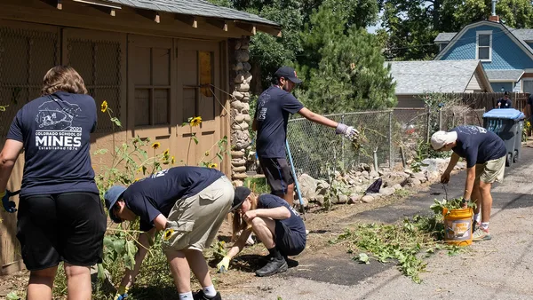 A group of people working in a garden.